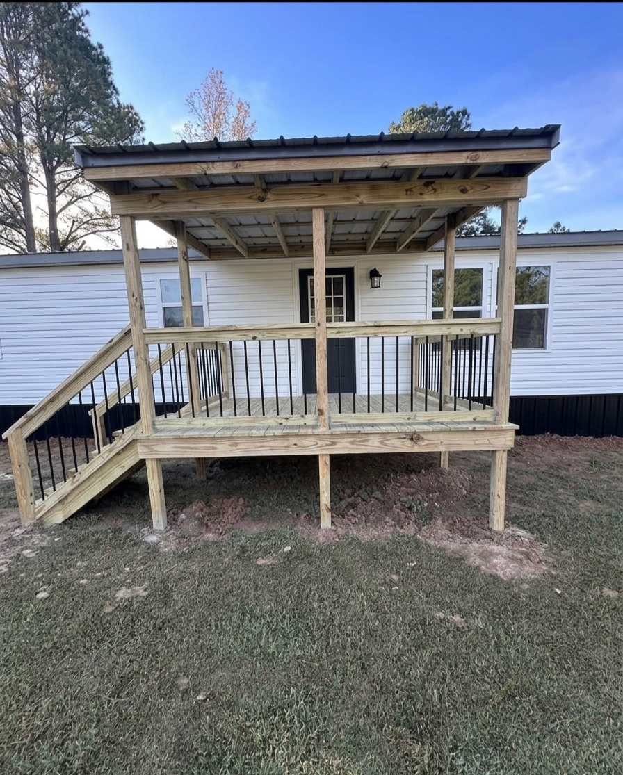 Covered porch with metal roof and black railing
